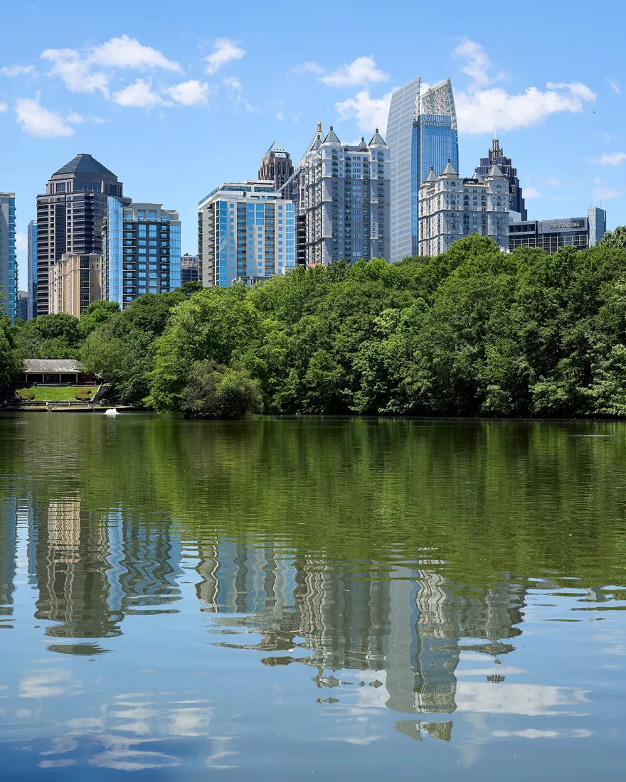 Atlanta skyline reflected across the park lake